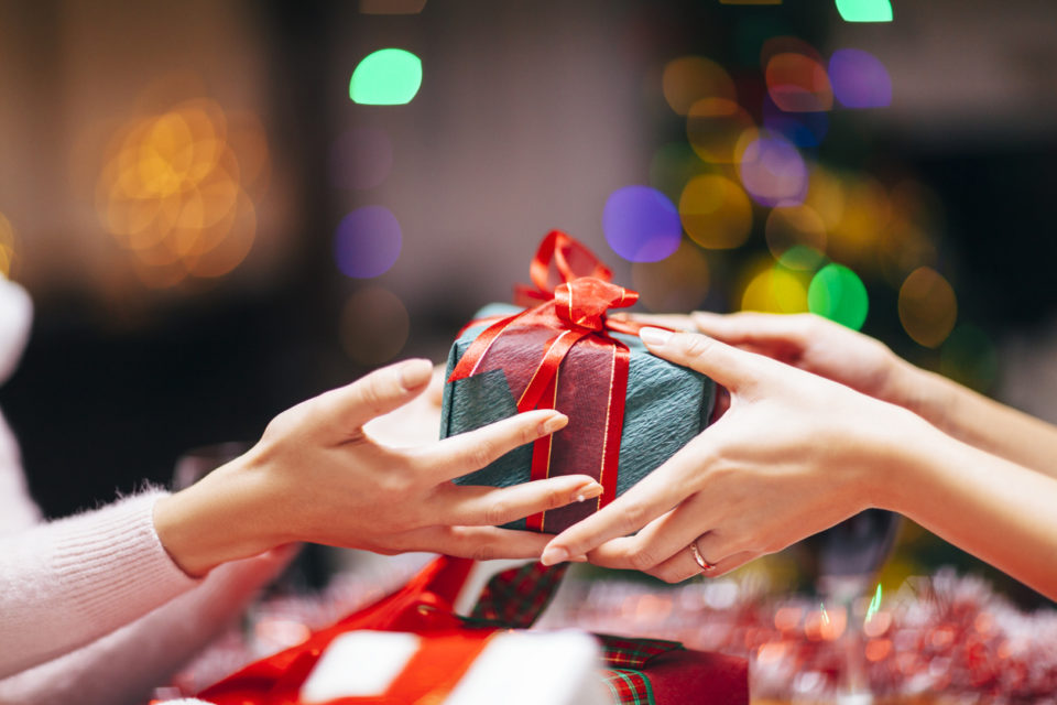 Close-up photography of two hands while giving gift.