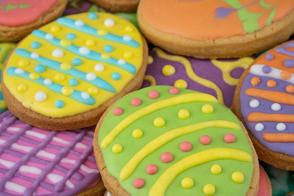 Easter decorated baked eggs, cookies as background.