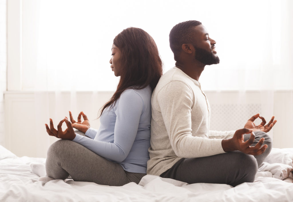 Husband and wife meditating together