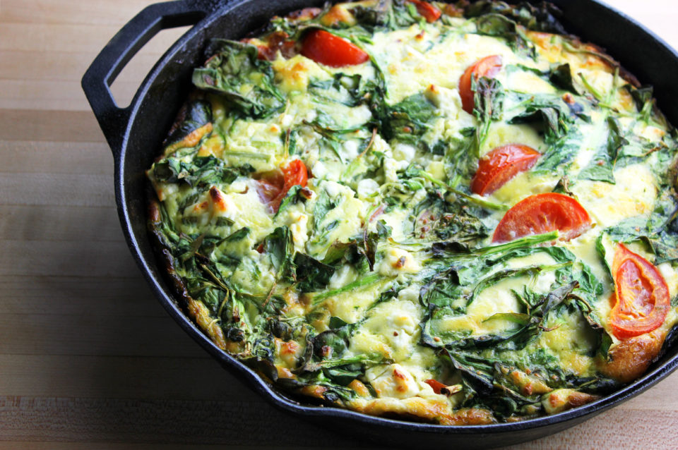 A freshly made spring vegetable frittata in a cast iron pan