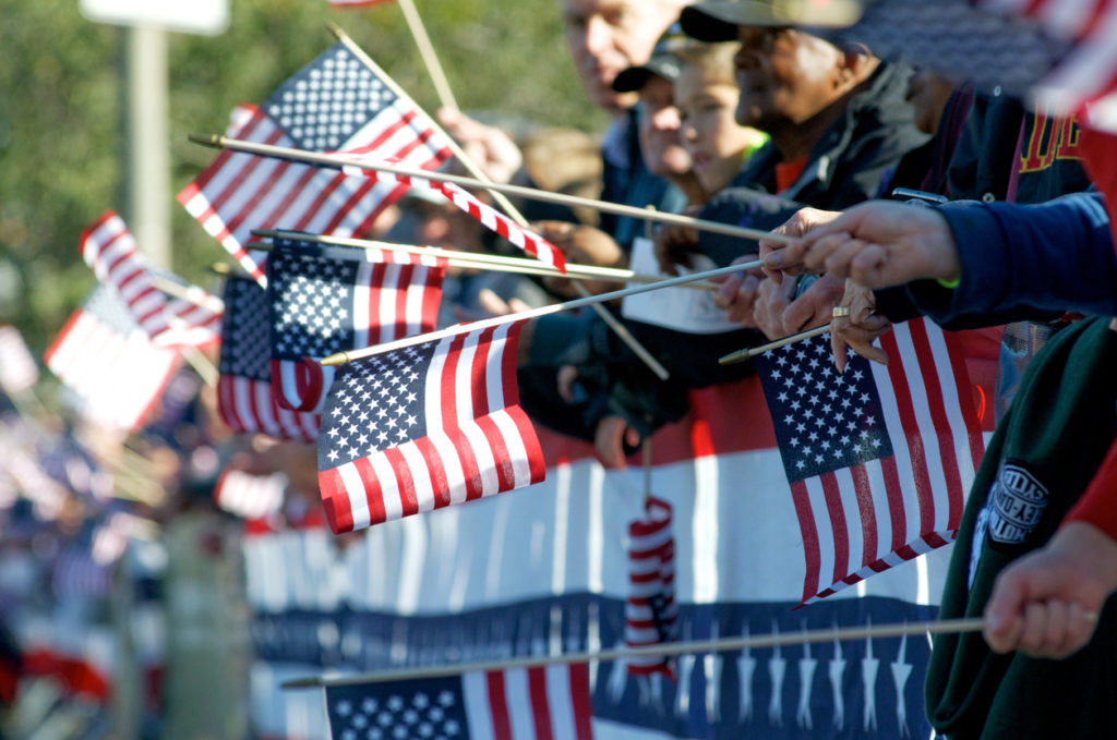 parade of people holding American flags