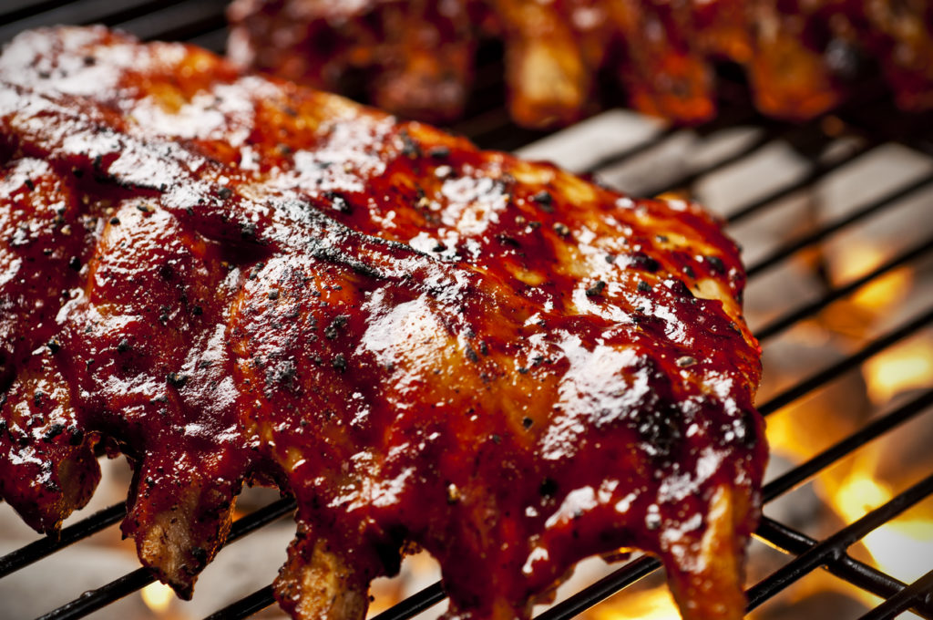 Barbecue ribs in sauce on the grill